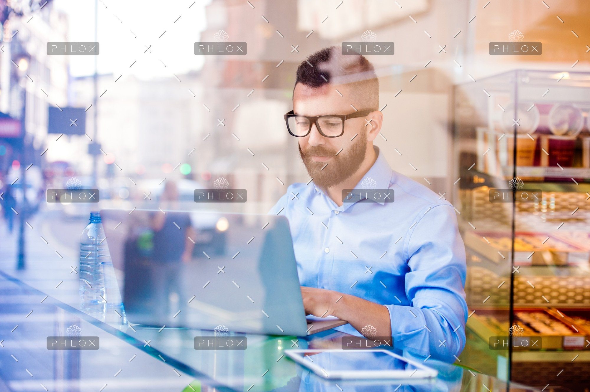 demo-attachment-146-Hipster-manager-in-cafe-working-on-laptop-by-window